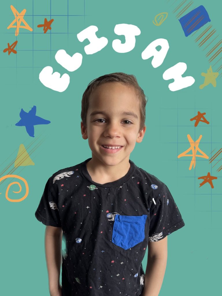 boy smiling in front of a teal background with doodle sketches