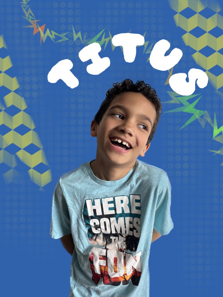 curly-haired child looking to the side in front of a blue background with green graphic prints