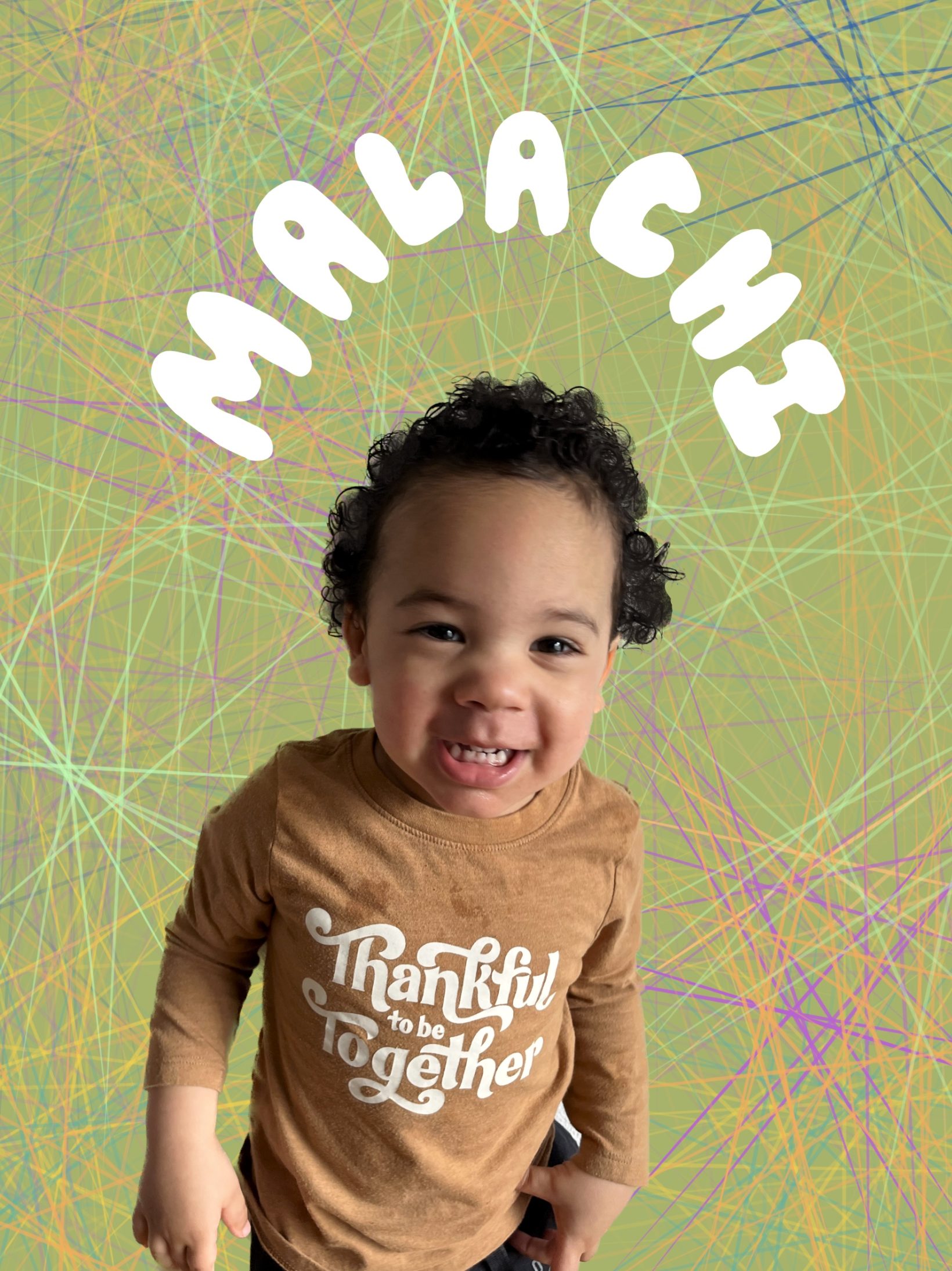 toddler smiling with green background and colorful lines